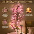 Cherry blossom LED branch lights glowing on bedroom wall